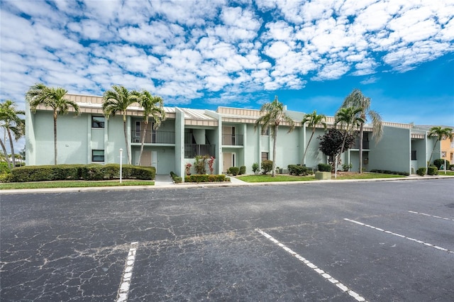 view of building exterior featuring uncovered parking