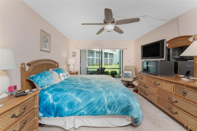 bedroom featuring access to outside, light carpet, ceiling fan, and a textured ceiling