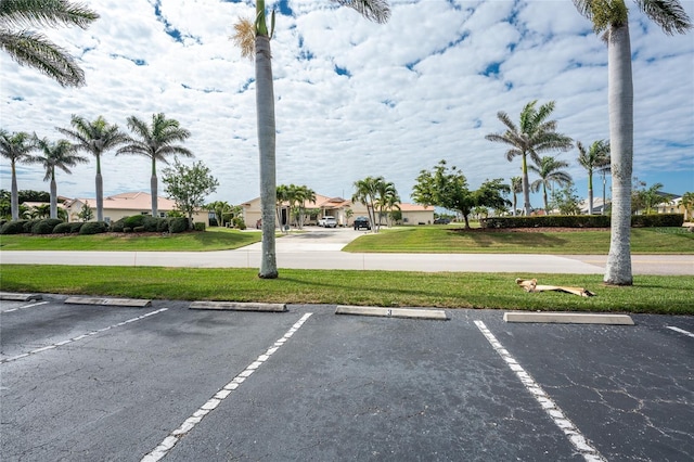 uncovered parking lot featuring a residential view