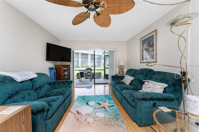 living area with ceiling fan and wood finished floors