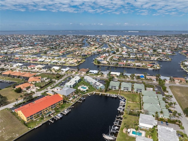 drone / aerial view featuring a water view and a residential view