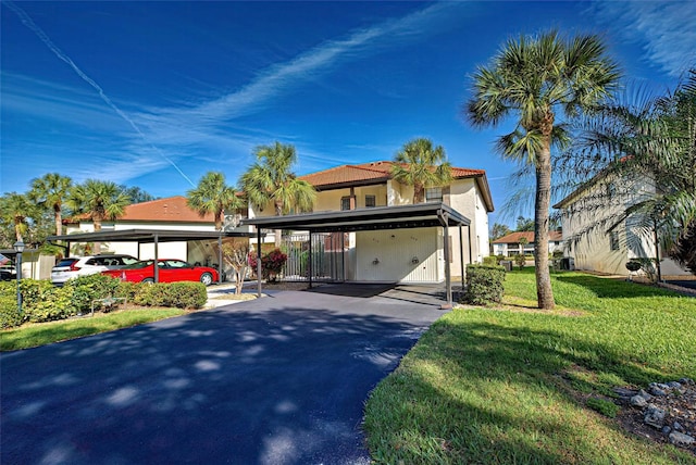 view of front of house with covered parking, a front lawn, and stucco siding