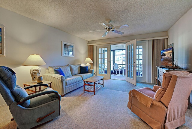 carpeted living room featuring a ceiling fan, french doors, and a textured ceiling