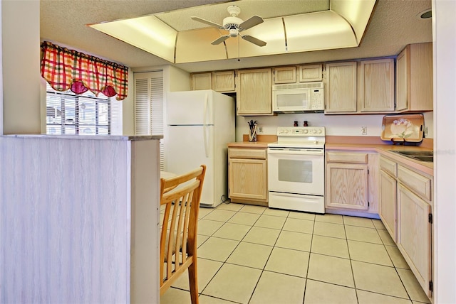 kitchen featuring ceiling fan, light countertops, white appliances, and light tile patterned flooring