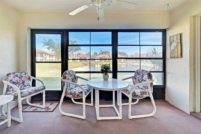 sunroom / solarium with a ceiling fan