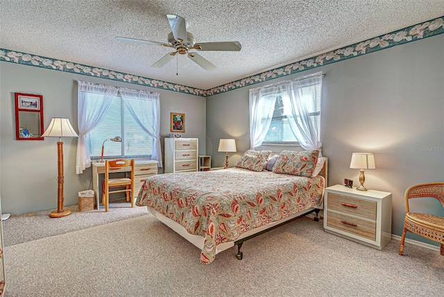 bedroom with a textured ceiling, carpet floors, and ceiling fan