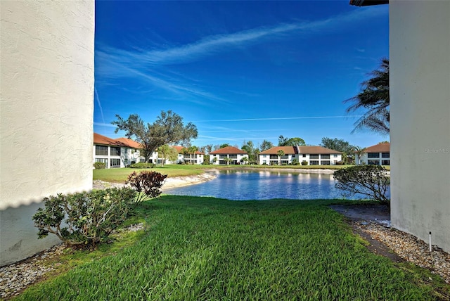 view of yard with a water view and a residential view