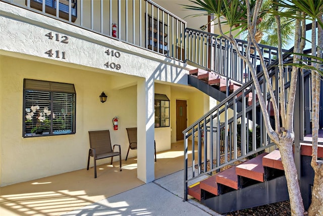 doorway to property featuring a patio and stucco siding