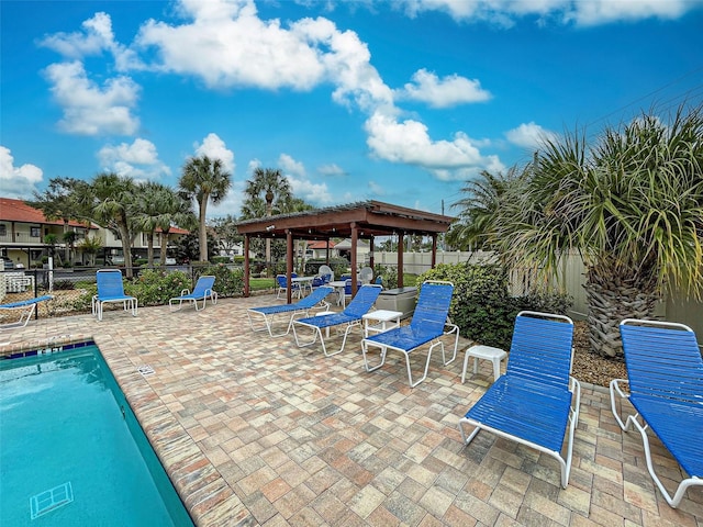 community pool featuring a gazebo, fence, and a patio