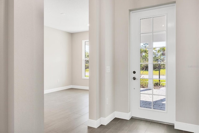 doorway featuring baseboards