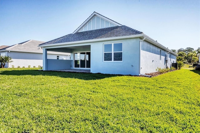 rear view of property featuring board and batten siding, cooling unit, a lawn, and stucco siding