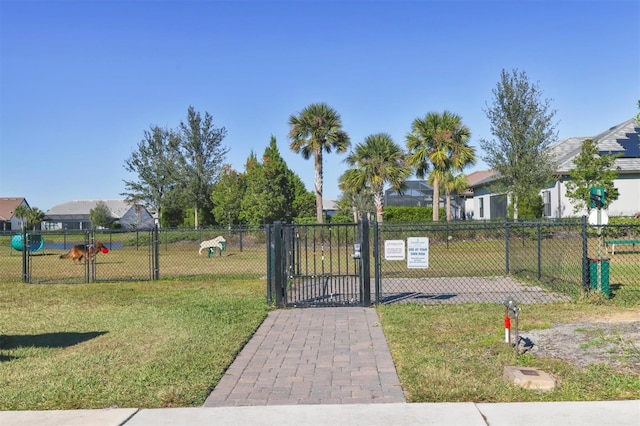 view of gate featuring a lawn and fence