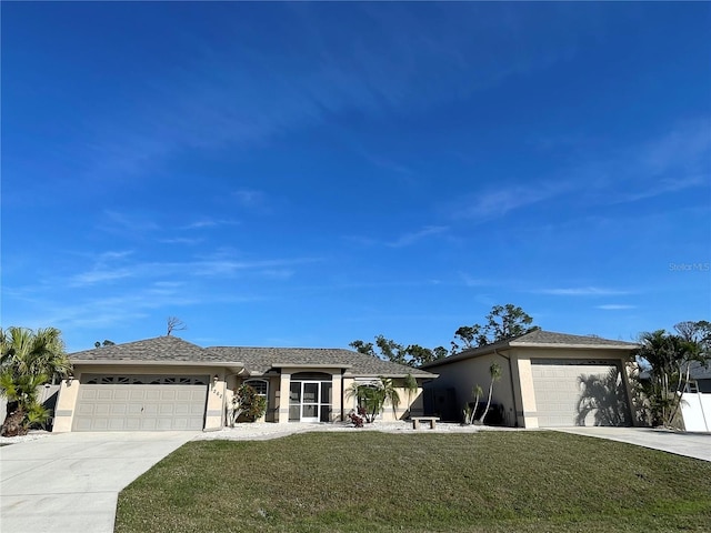 ranch-style home with concrete driveway, a front yard, an attached garage, and stucco siding