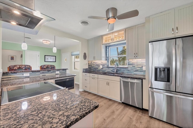 kitchen featuring visible vents, appliances with stainless steel finishes, white cabinets, and pendant lighting