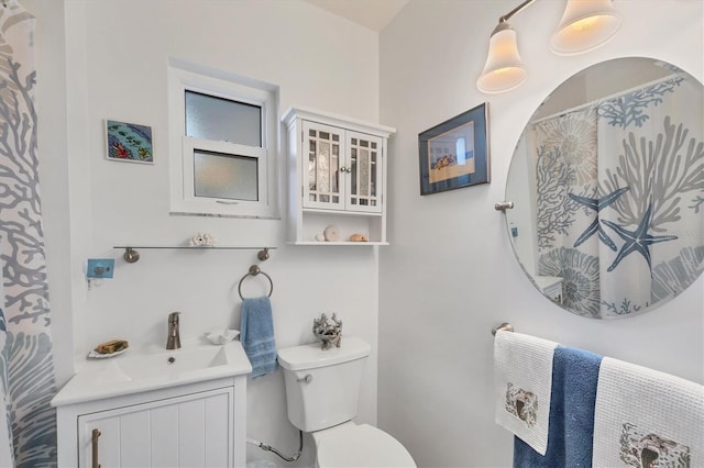 bathroom featuring toilet and vanity