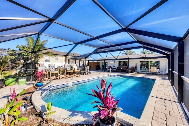 pool with a patio area and glass enclosure