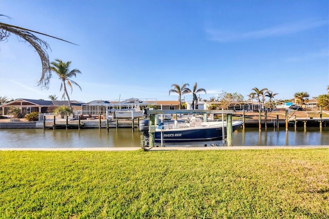 dock area with a water view and a yard