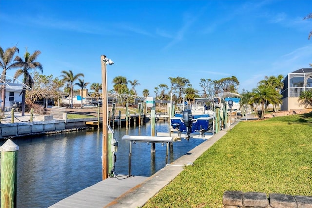 view of dock with a lawn, a water view, and boat lift