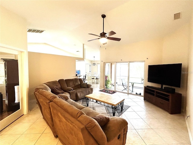 living area featuring light tile patterned flooring, visible vents, and lofted ceiling