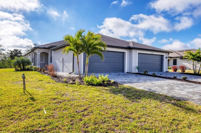 view of front of home featuring a front yard, decorative driveway, an attached garage, and stucco siding