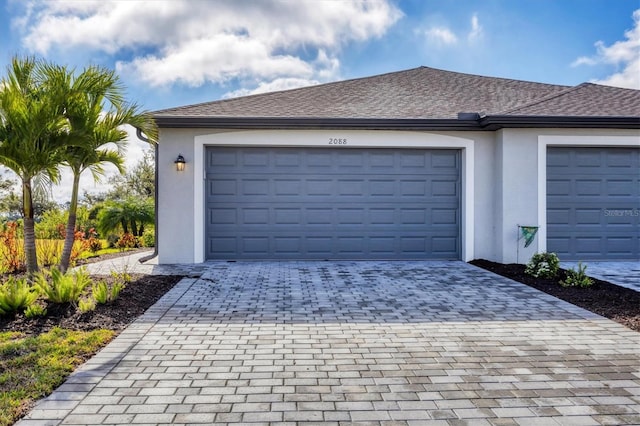 garage with decorative driveway