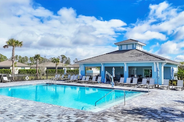 pool featuring fence and a patio