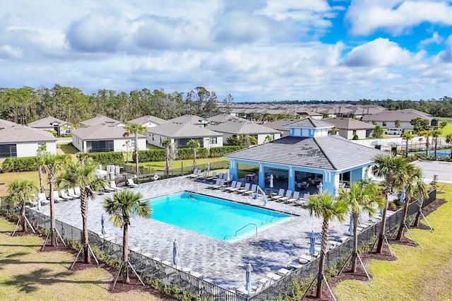 community pool featuring a residential view, a fenced backyard, a patio, and a gazebo