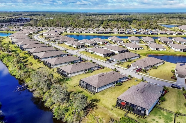 birds eye view of property featuring a water view and a residential view