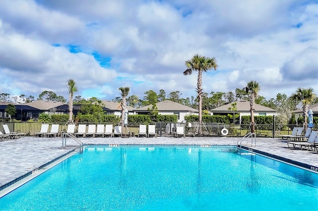 pool featuring a patio and fence