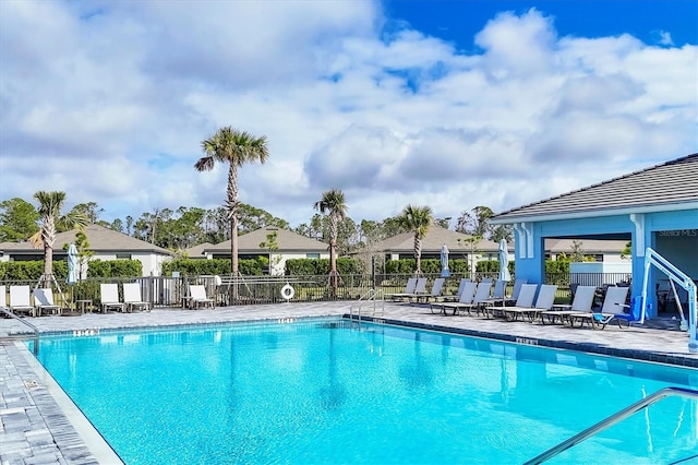 pool featuring fence and a patio