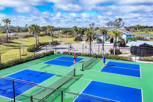 view of tennis court featuring fence