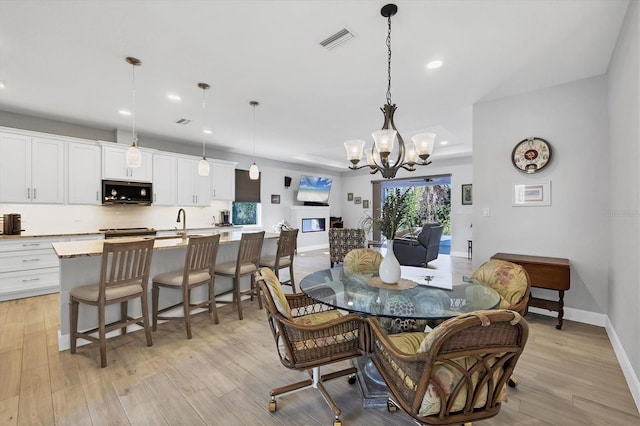 dining space featuring light wood-type flooring, visible vents, baseboards, and recessed lighting