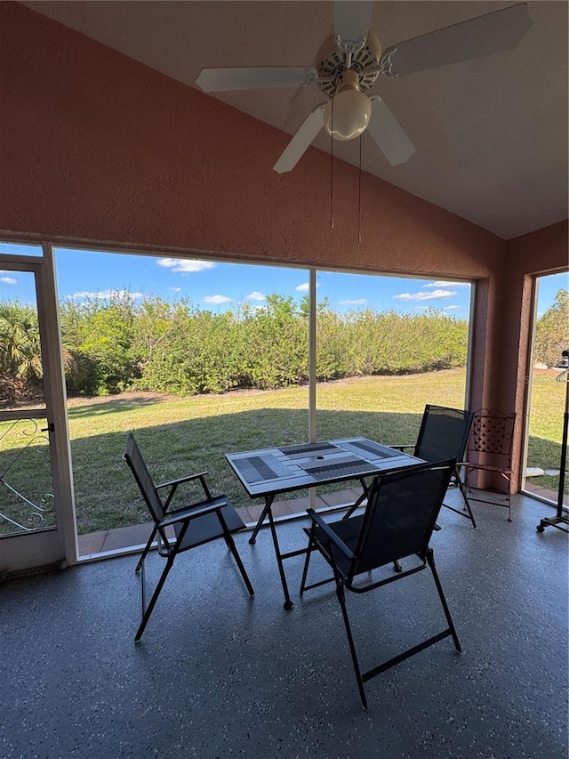 unfurnished sunroom with lofted ceiling and ceiling fan