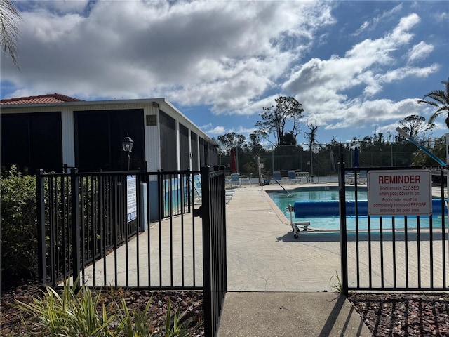 community pool featuring a patio area and fence