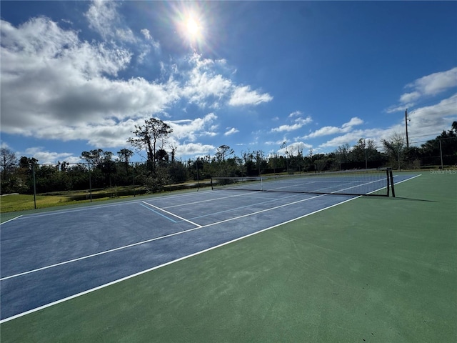 view of tennis court featuring fence