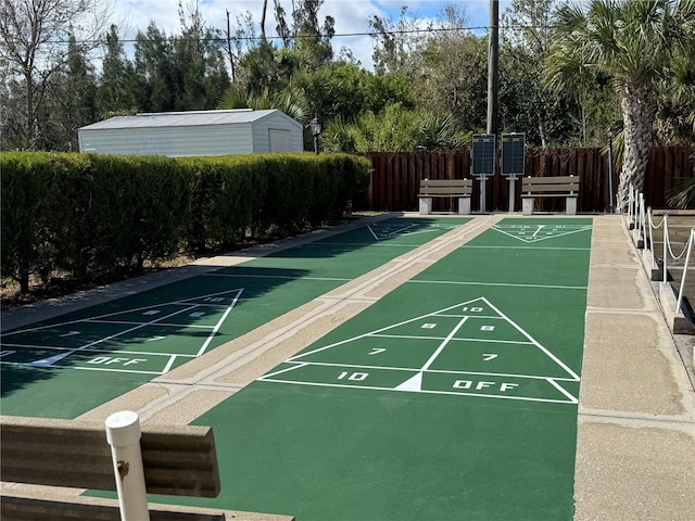 surrounding community featuring fence and shuffleboard