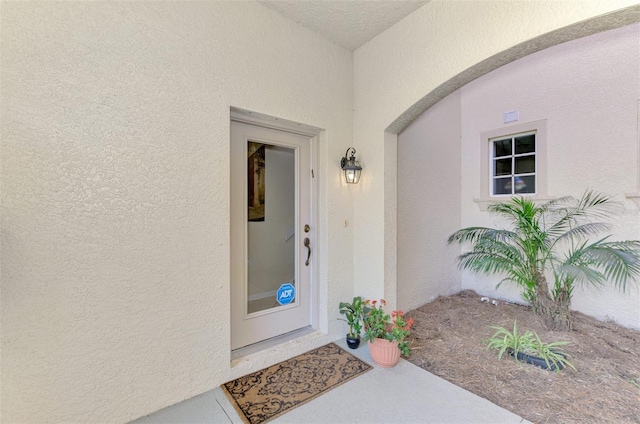 entrance to property featuring stucco siding