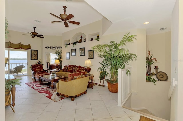 living area with visible vents, a water view, and light tile patterned flooring