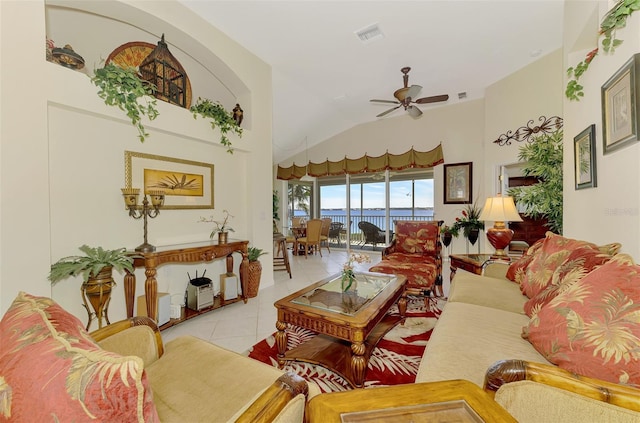 living room with light tile patterned floors, ceiling fan, and vaulted ceiling