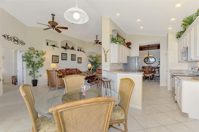 dining room with light tile patterned floors, lofted ceiling, a ceiling fan, and recessed lighting