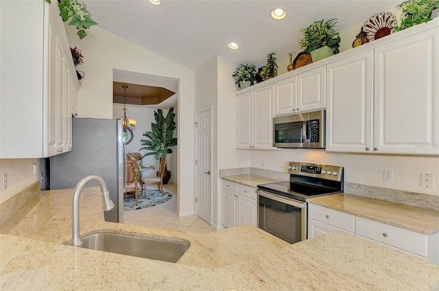 kitchen with appliances with stainless steel finishes, white cabinets, a sink, and recessed lighting