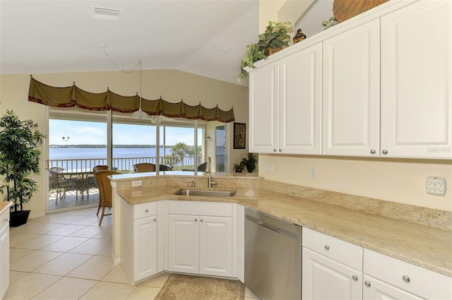 kitchen with a water view, stainless steel dishwasher, white cabinets, a sink, and light tile patterned flooring