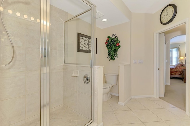 ensuite bathroom featuring a stall shower, baseboards, connected bathroom, toilet, and tile patterned floors