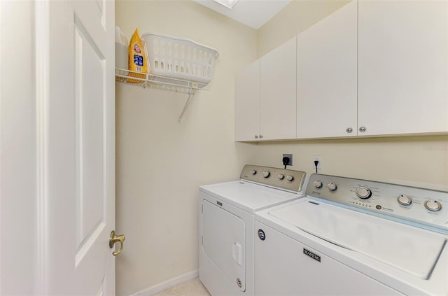 laundry room featuring cabinet space, baseboards, and separate washer and dryer