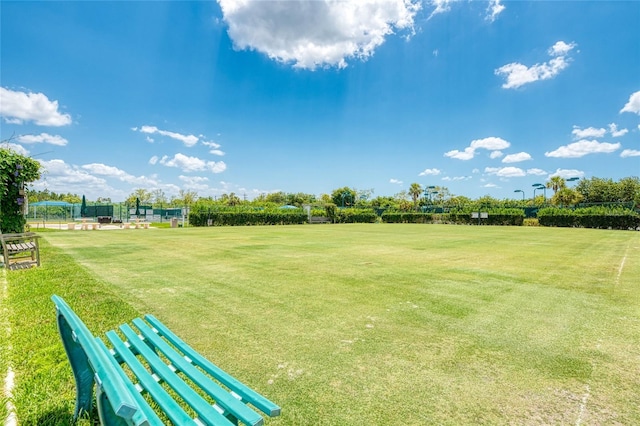 surrounding community featuring fence and a yard