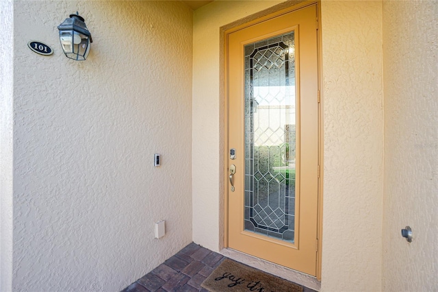 doorway to property with stucco siding