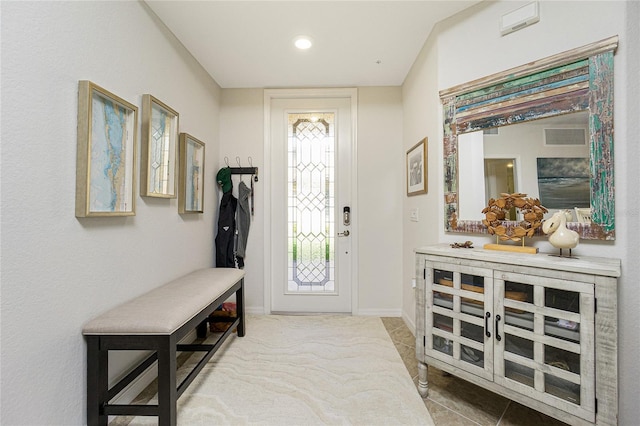 foyer entrance with visible vents and baseboards