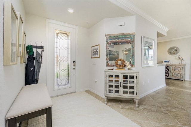 foyer entrance with baseboards and crown molding