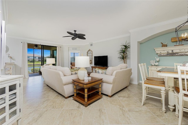 living room with visible vents, ornamental molding, and a ceiling fan