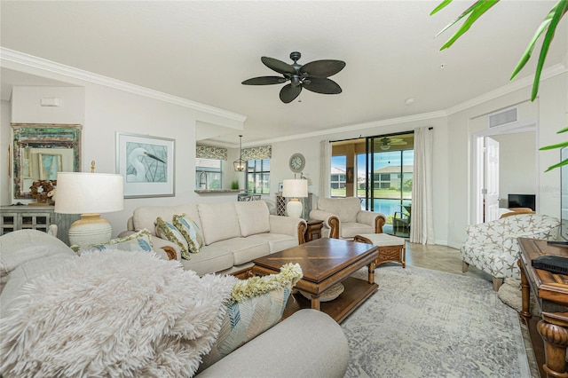 living room featuring ceiling fan, visible vents, and crown molding